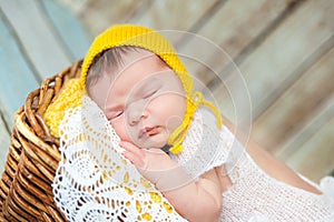 Cute newborn baby girl in a pink knit romper