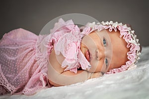 cute newborn baby girl in retro dress and cap