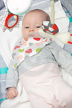 Cute newborn baby girl in a rocking seat