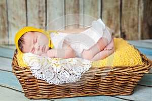 Cute newborn baby girl in a pink knit romper