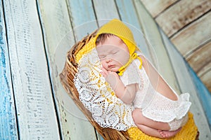 Cute newborn baby girl in a pink knit romper