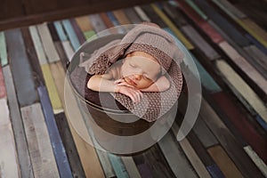 Cute newborn baby in the hat. Sleeping baby on a dark background. Closeup portrait of newborn baby. Baby goods packing template. N