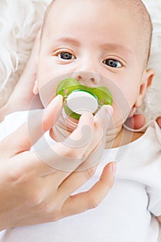 Cute newborn baby with a pacifier