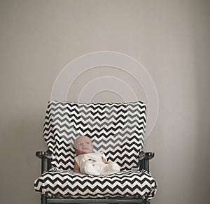 Cute newborn baby sitting in the big chair