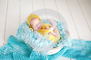 Cute newborn baby sleeping in a basket