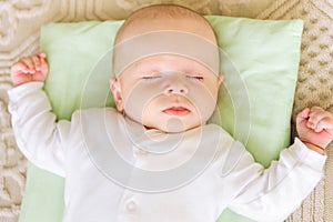 Cute newborn baby sleeping in bed