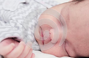 Cute newborn baby sleeping, face closeup