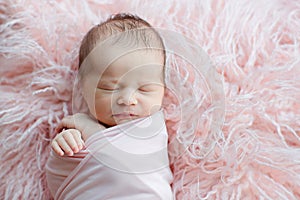 Cute newborn baby sleeping on fur pink blanket. Baby goods packaging template. Healthy and medical concept. Copy space