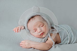 Cute newborn baby sleeping on gray blanket. Baby goods packaging template. Healthy and medical concept. Copy space
