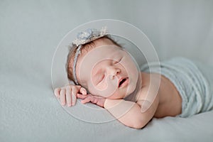 Cute newborn baby sleeping on gray blanket. Baby goods packaging template. Healthy and medical concept. Copy space