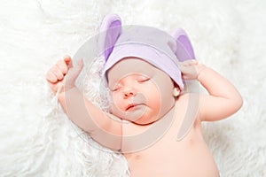 Cute newborn baby sleeps in a hat with ears