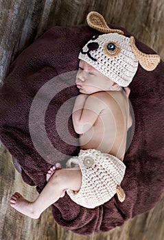 Cute newborn baby sleeps in a knitted hat