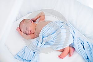 Cute newborn baby in white bed