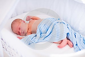 Cute newborn baby in white bed