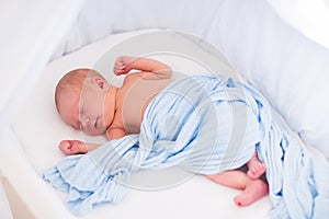 Cute newborn baby in white bed