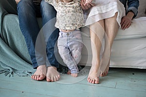 Cute newborn foot with family members