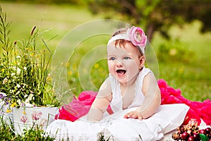 Cute newborn girl smiling on grass