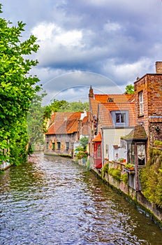 Cute old canalside houses Bruges city view at summer day Belgium