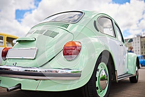 Cute old car, rear view, turquoise color