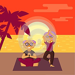 Cute older couple dressed in sports clothes practicing yoga exercises on the beach at sunset