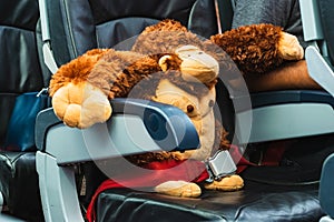 Cute orangutan doll passenger of airplane sitting in comfortable seat - Traveler or vacation concept