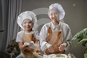 Cute oriental family with mother, daughter cooking in the kitchen on Ramadan, Kurban-Bairam. Funny family at cook photo