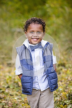 Cute outdoor portrait of a smiling African American boy