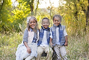 Cute outdoor portrait of three racially diverse children