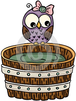 Cute owl with wooden tub for a bath