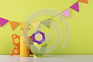 Cute paper butterfly made from a toilet paper tube. spring background