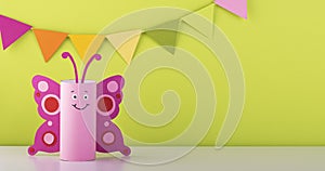 Cute paper butterfly made from a toilet paper tube. spring background