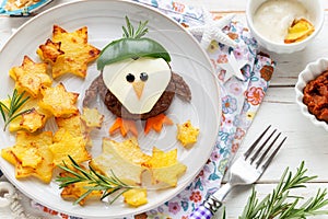 Cute penguin shaped burger with baked potatoes for kids