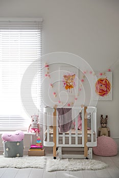 Cute pictures and crib in baby room interior