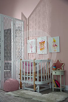 Cute pictures and crib in baby room interior