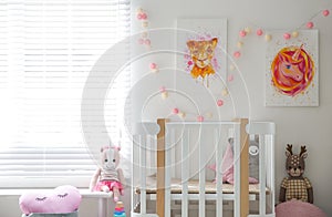 Cute pictures and crib in baby room interior