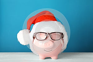 Cute piggy bank with Santa hat and glasses
