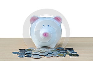 Cute piggy bank on a stack of cash. Concept of savings and money