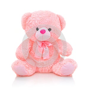 Cute pink bear doll with bow on white background with shadow reflection. Playful bright pink bear.