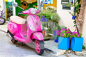 Cute pink motorbike in streets of Kos island, Greece