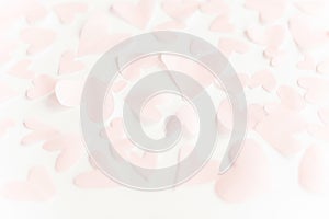 Cute pink pastel hearts on white paper  background. Happy valentines day. Pink paper heart cutouts on white backdrop, gentle image