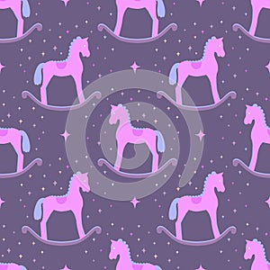 Cute pink vector rocking horses isolated on violet background. Baby toy seamless pattern