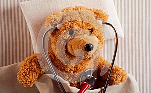 Cute plush teddy bear using a stethoscope