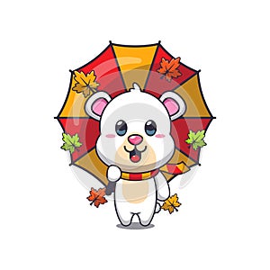 Cute polar bear with umbrella at autumn season.
