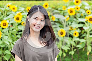 Cute portrait asian Thai teen smile with sunflower