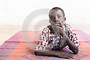 Cute Portrait Shot of Little African Boy Posing with Hand under Chin