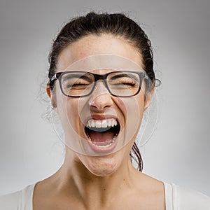 Woman yelling on grey background photo