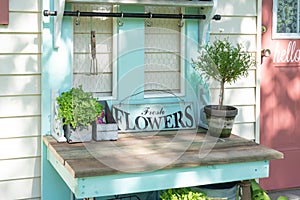 Cute potting bench with a sign that says fresh flowers