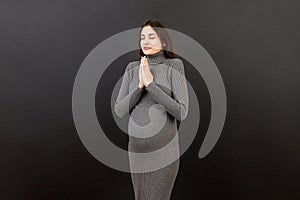 cute pregnant woman praying on colored background isolated