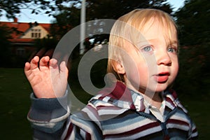 Cute preschool boy waving