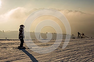 Cute preschool child, boy, skiing happily in Austrian Apls